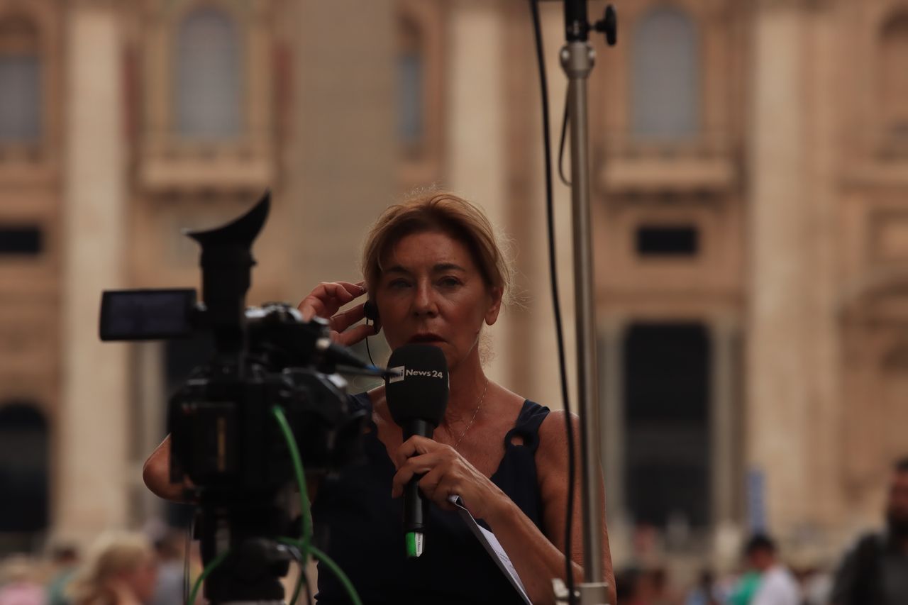 Services Journalist reporting live from Vatican City, capturing the essence of urban broadcast journalism.