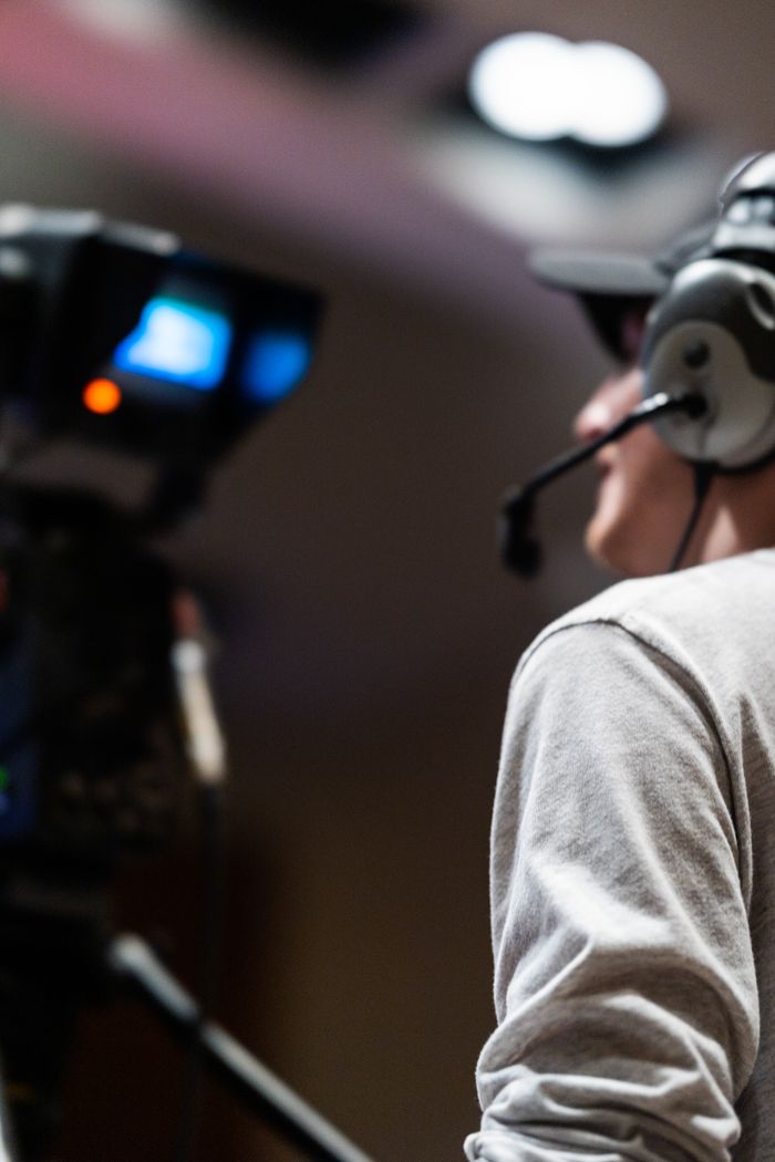 Services Professional cameraman capturing live events using a broadcast camera and headset.