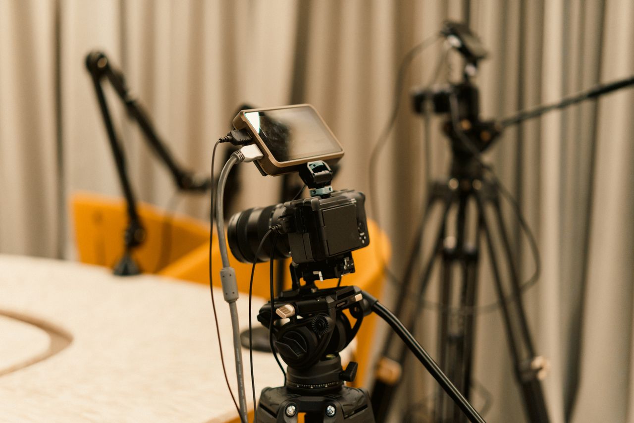 Services A professional studio with cameras, microphones, and other equipment ready for recording or live streaming.