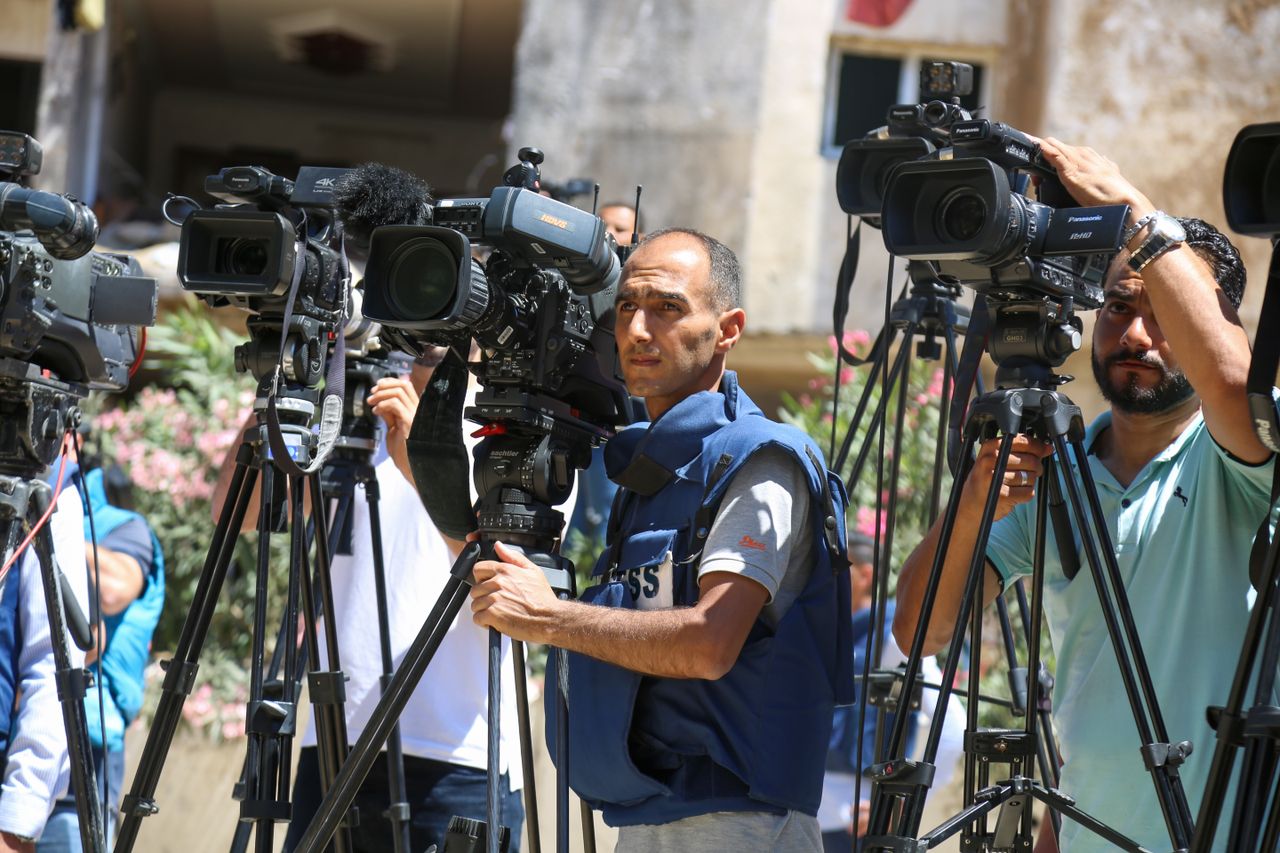 Services Journalists filming a live broadcast outdoors in Gaza Strip.